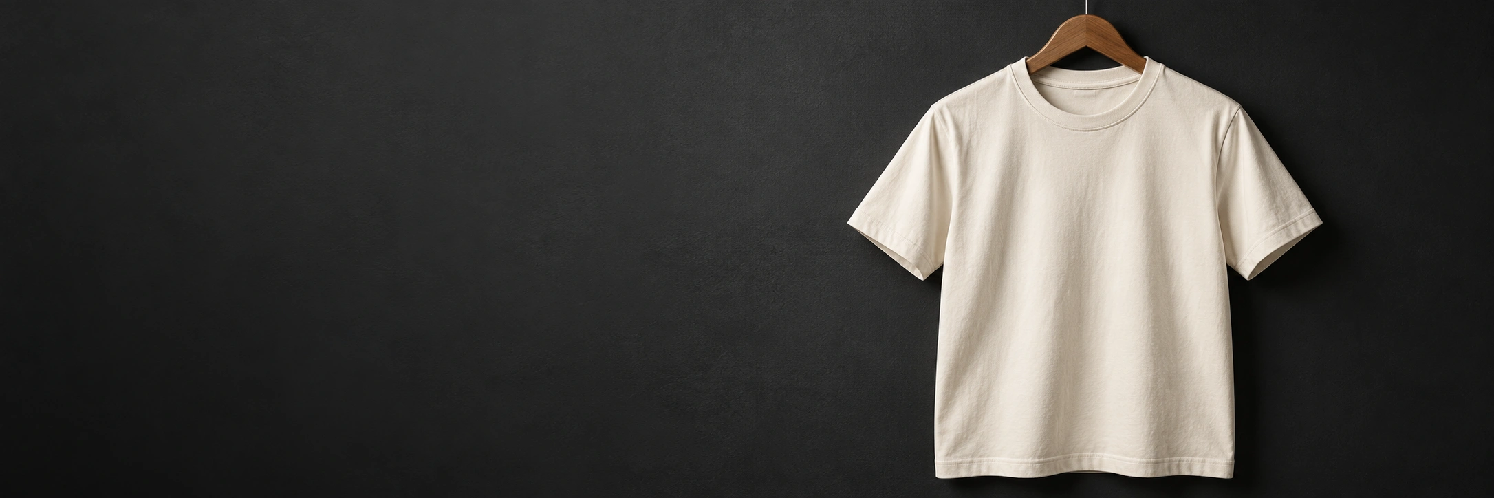 Cream cotton T-shirt on a wooden hanger